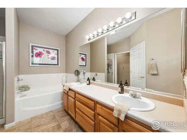a bathroom with a sink a large mirror and a bathtub