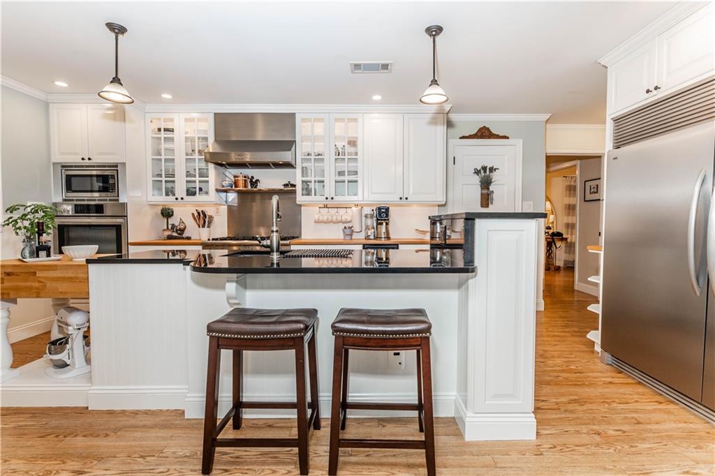 508 College Lodge Road Indiana, PA 15701 - Photo 10 of 25 a kitchen with stainless steel appliances kitchen island granite countertop a refrigerator a stove a oven a sink with a dining table and chairs