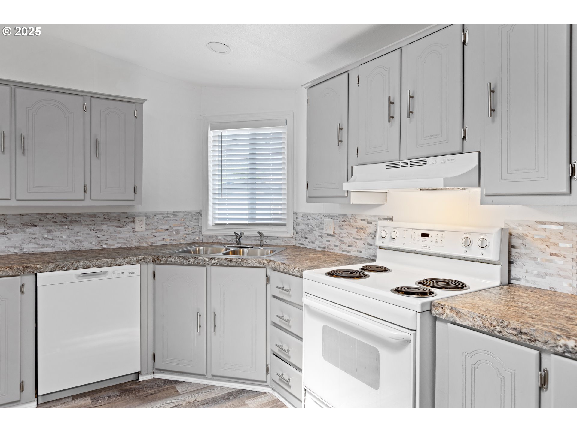 78 Manor Loop Roseburg, OR 97471 - Photo 11 of 45 a kitchen with granite countertop cabinets and white appliances