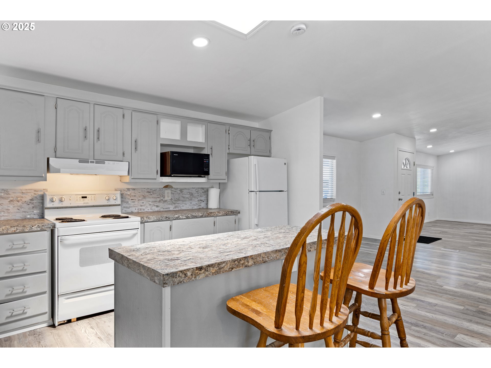 78 Manor Loop Roseburg, OR 97471 - Photo 13 of 45 a kitchen with kitchen island a appliances dining table and chairs
