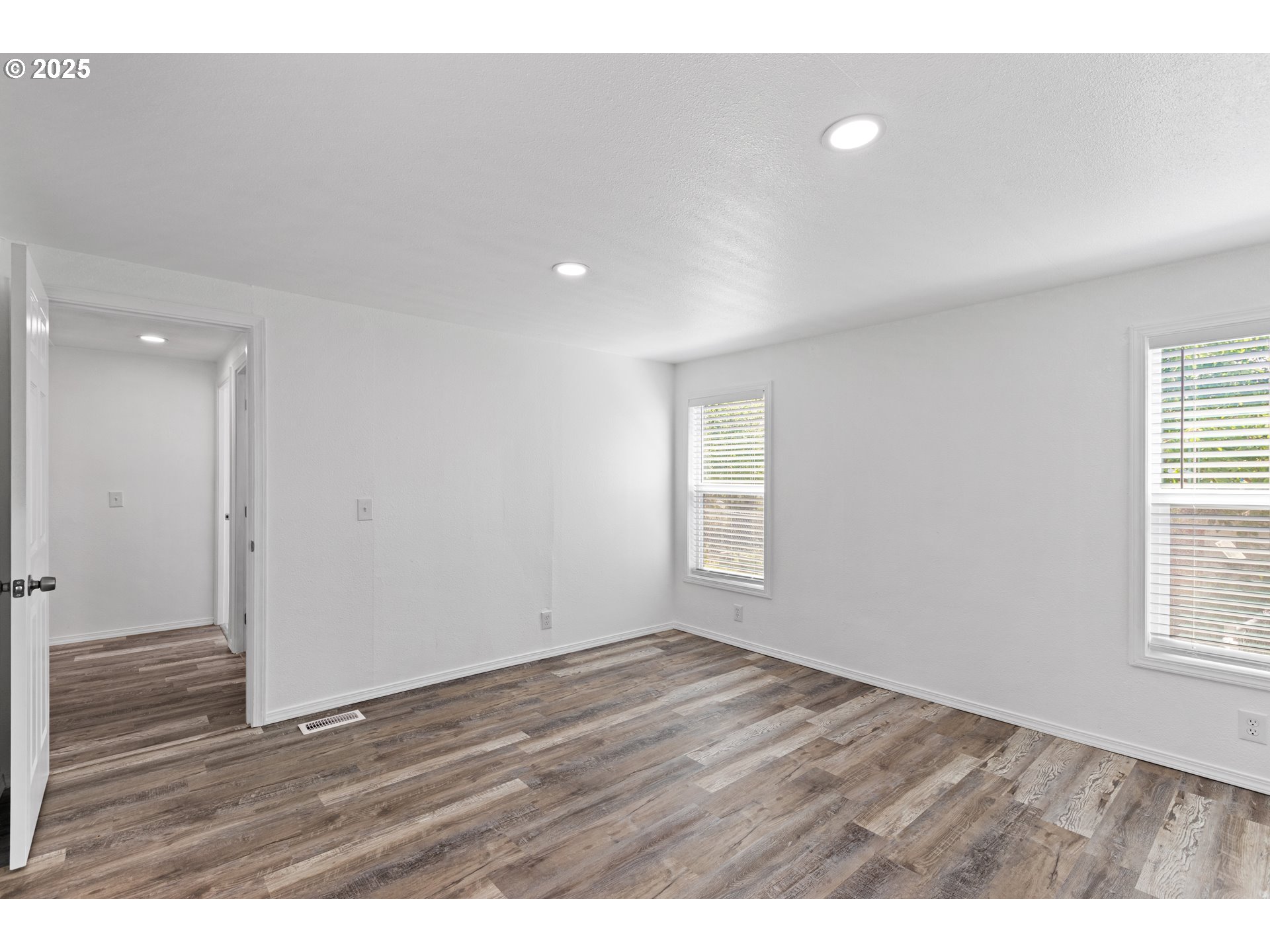 78 Manor Loop Roseburg, OR 97471 - Photo 21 of 45 a view of an empty room with wooden floor and a window