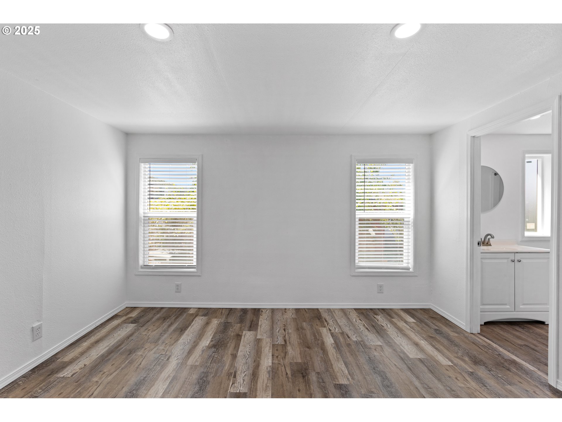 78 Manor Loop Roseburg, OR 97471 - Photo 22 of 45 an empty room with wooden floor and windows