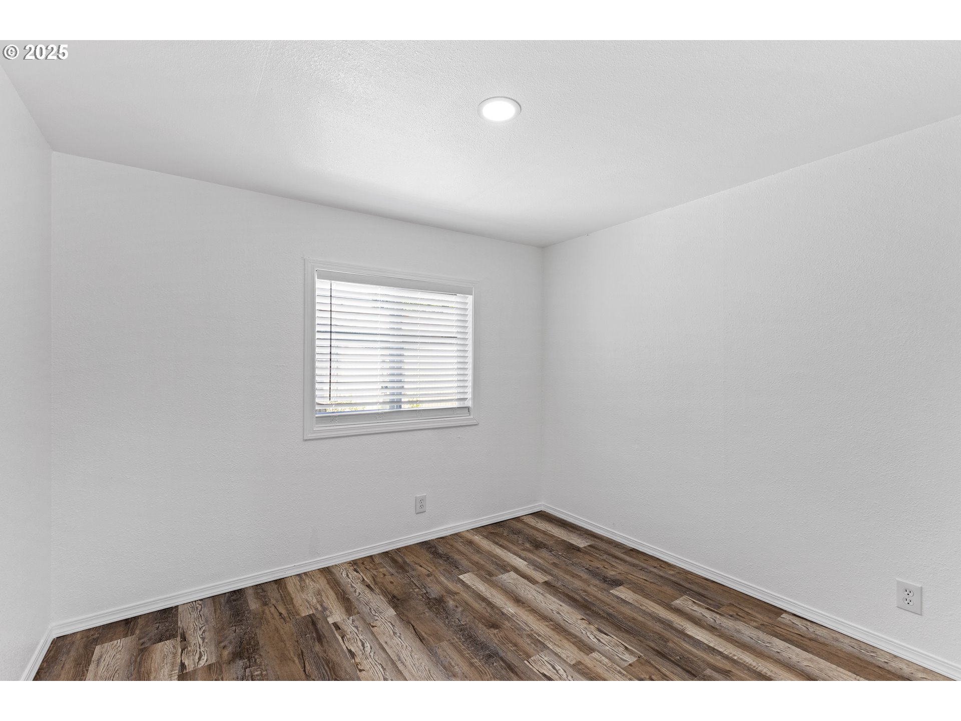 78 Manor Loop Roseburg, OR 97471 - Photo 29 of 45 a view of an empty room with wooden floor and a window