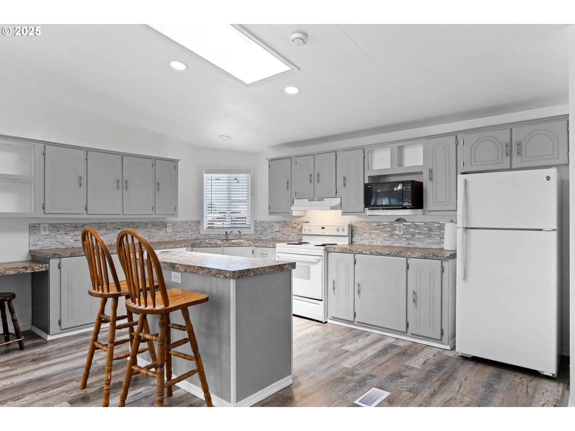 78 Manor Loop Roseburg, OR 97471 - Photo 10 of 45 a kitchen with a refrigerator a stove a sink dishwasher with a dining table and chairs