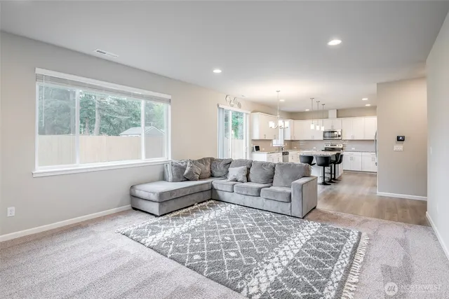 a living room with furniture and a large window