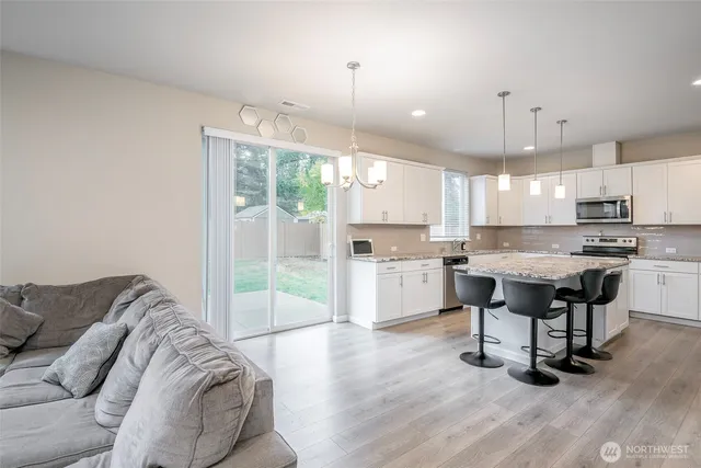 a living room with furniture and kitchen view