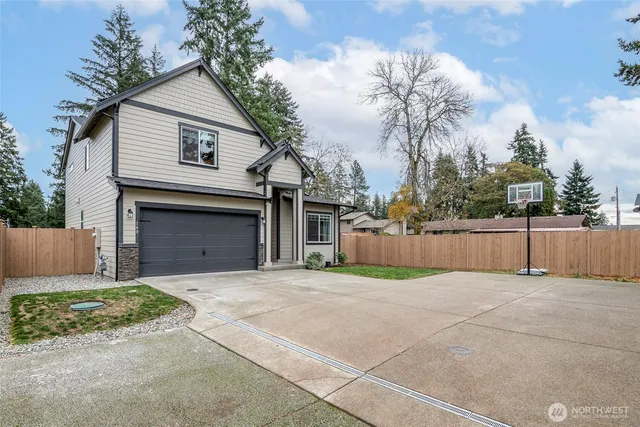 a view of a house with a yard and garage