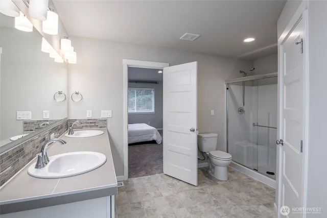 a spacious bathroom with a sink a toilet and shower