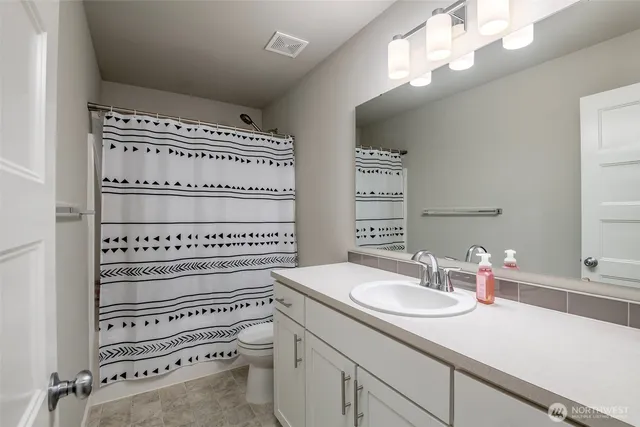 a bathroom with a sink a vanity and a mirror