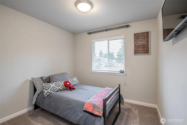 a living room with a bed furniture and a window