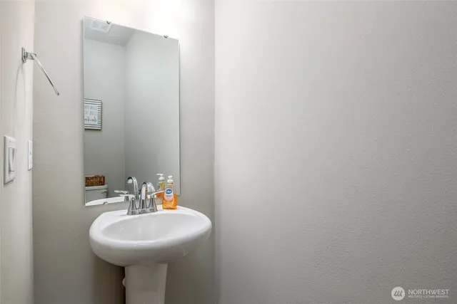 a bathroom with a sink a mirror and a toilet