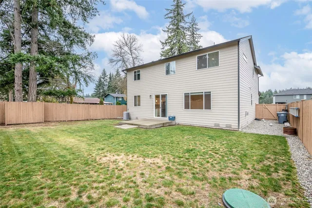 a view of a backyard with plants and a garden