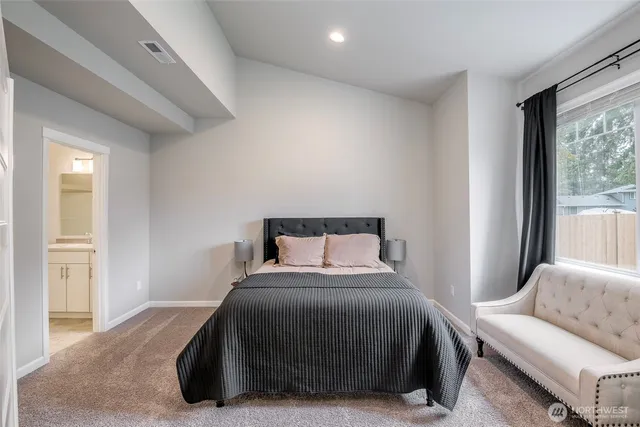 a bedroom with a bed and a couch