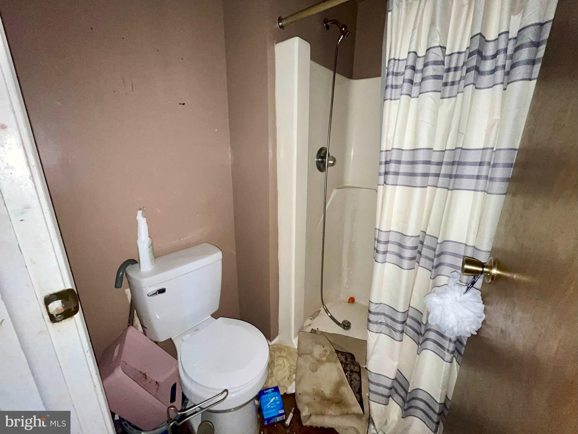 12366 Bonfire Drive Reisterstown, MD 21136 - Photo 12 of 20 a white toilet sitting next to a shower curtain