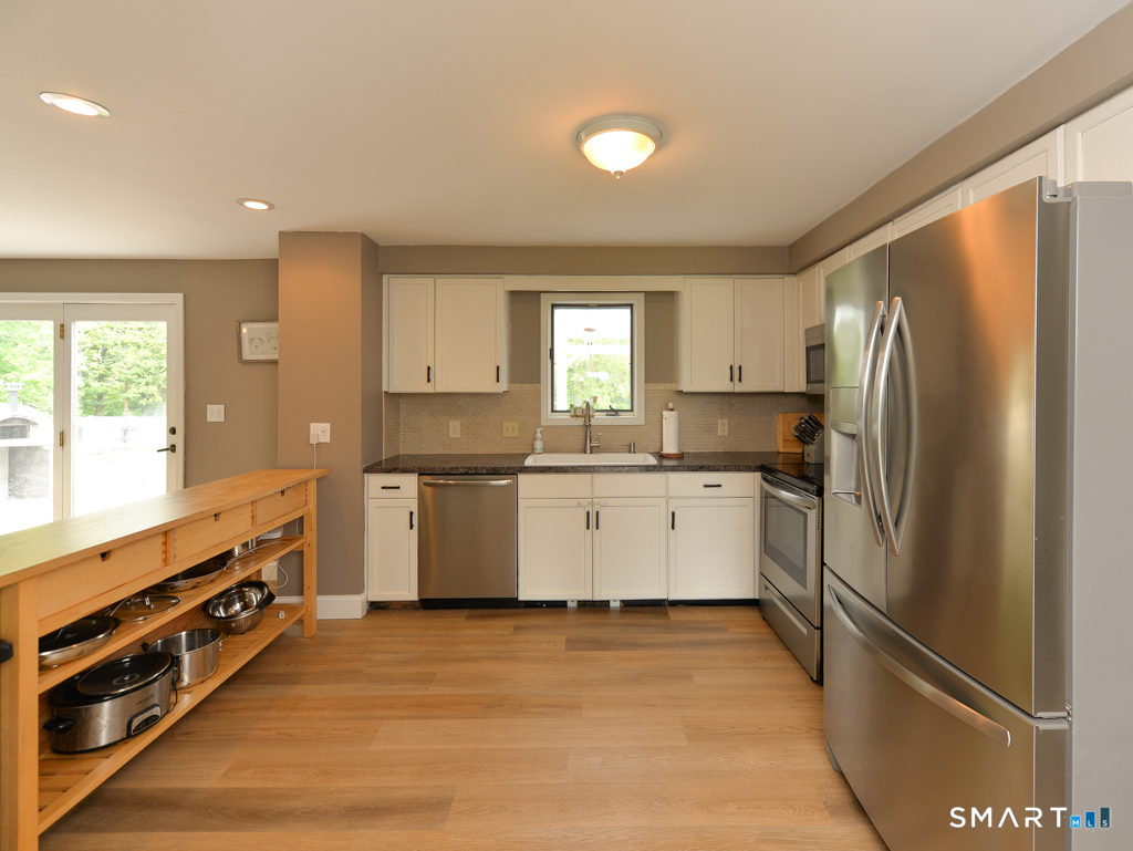 109 Harrison Lane Bethlehem, CT 06751 - Photo 8 of 28 a kitchen with granite countertop a refrigerator stove top oven and sink