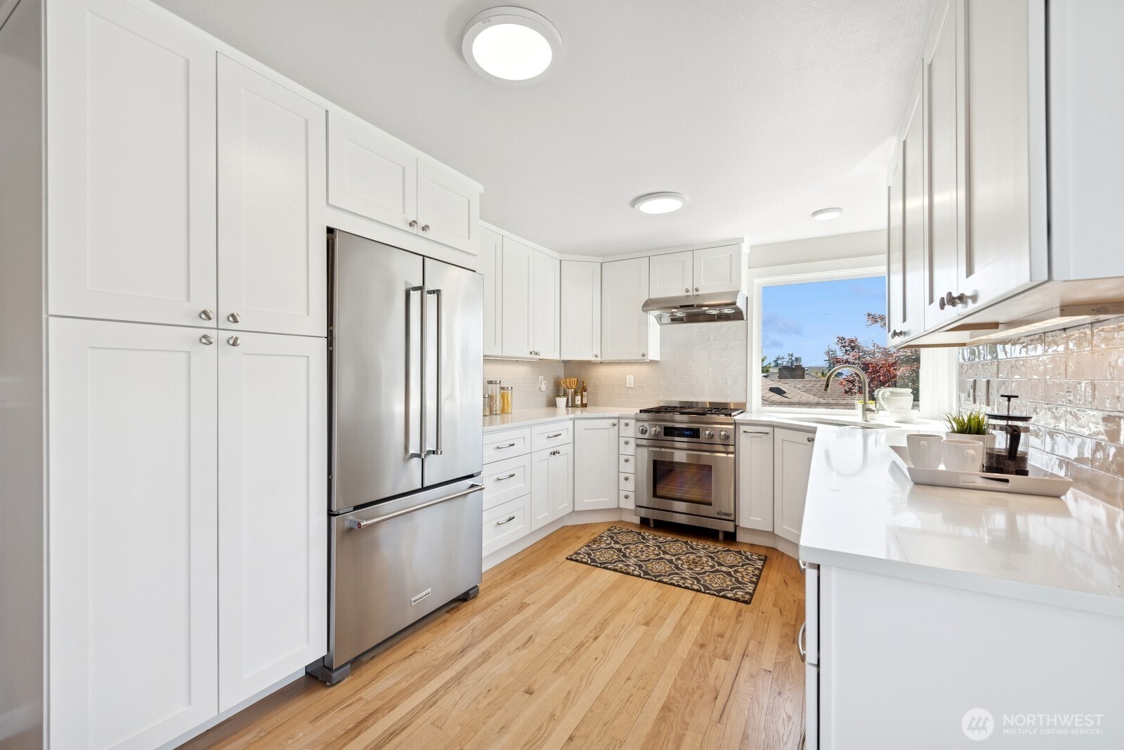 918 Daley Street Edmonds, WA 98020 - Photo 5 of 32 a kitchen with white cabinets and stainless steel appliances