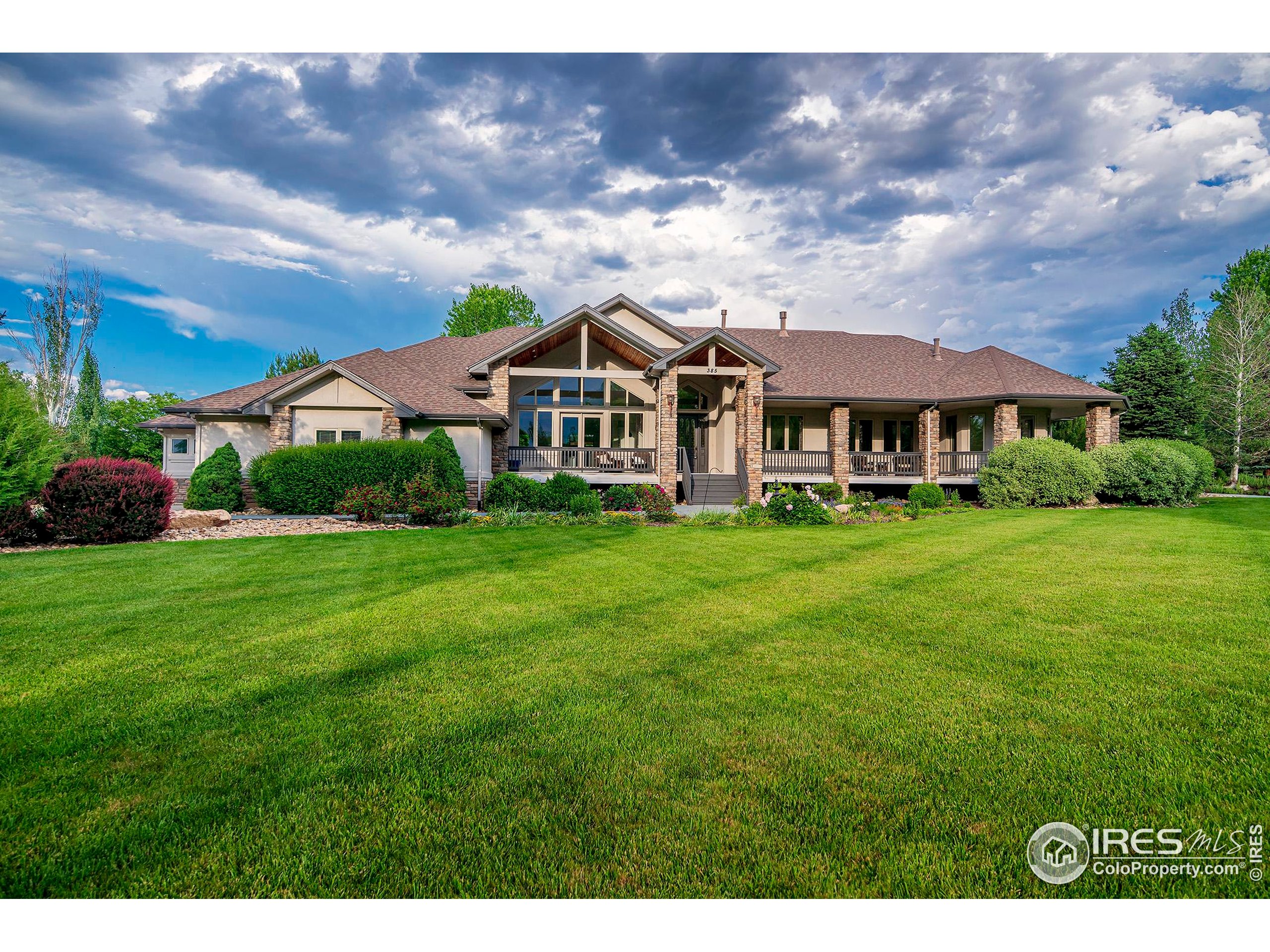 385 Baxter Farm Lane Erie, CO 80516 - Photo 1 of 40 a front view of a house with garden