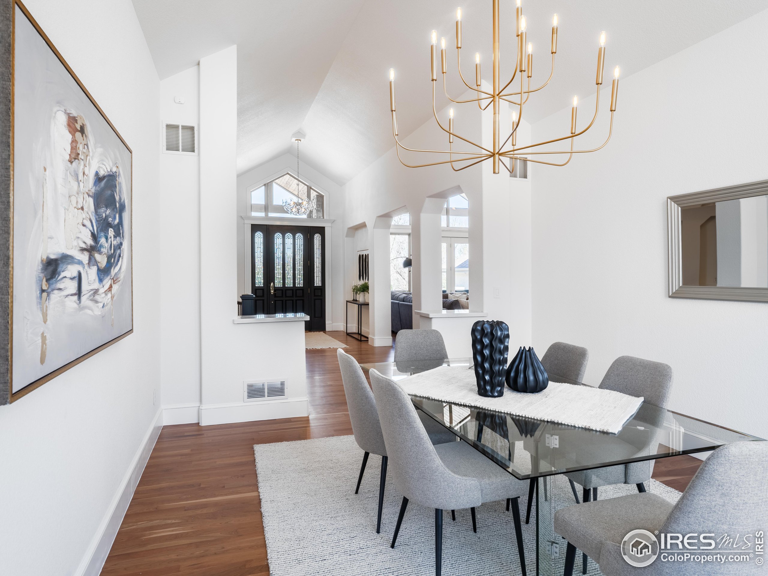 385 Baxter Farm Lane Erie, CO 80516 - Photo 18 of 40 a view of a dining room with furniture and wooden floor