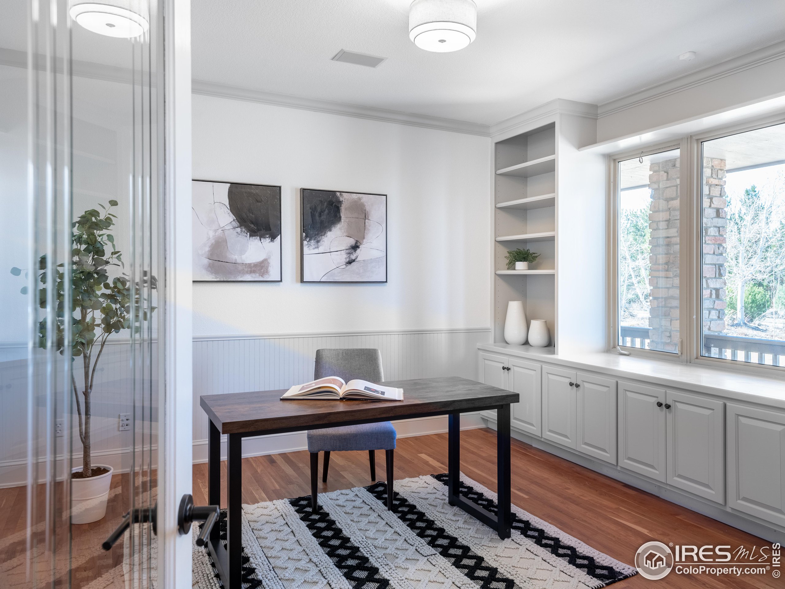 385 Baxter Farm Lane Erie, CO 80516 - Photo 19 of 40 a view of a workspace with furniture and window