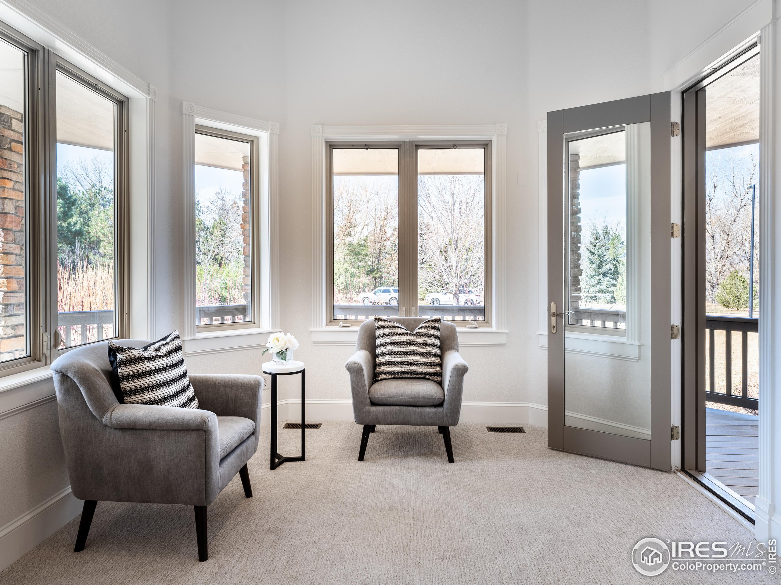 385 Baxter Farm Lane Erie, CO 80516 - Photo 21 of 40 a living room with furniture and a floor to ceiling window