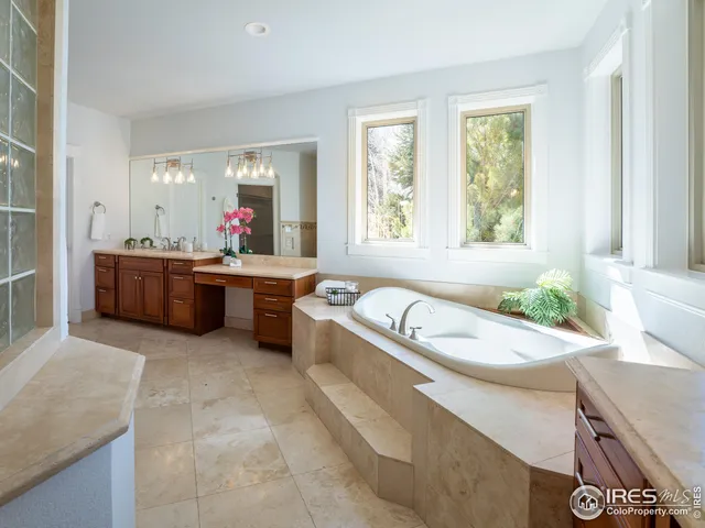 a large white kitchen with a large window
