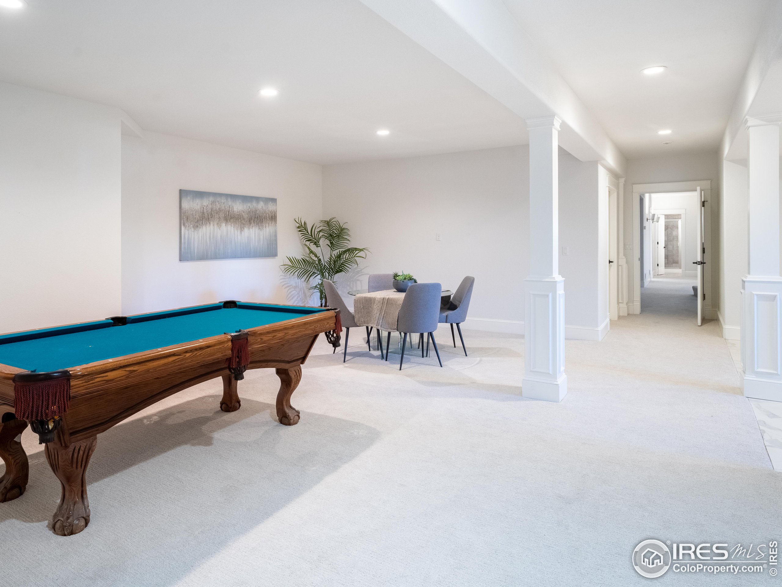 385 Baxter Farm Lane Erie, CO 80516 - Photo 35 of 40 a living room with furniture a rug and white walls