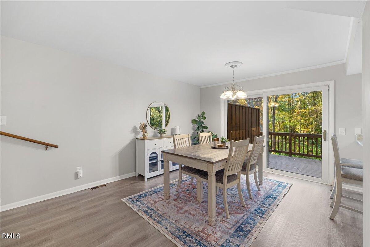 5821 Mapleridge Road Raleigh, NC 27609 - Photo 12 of 38 a view of a dining room with furniture window and wooden floor