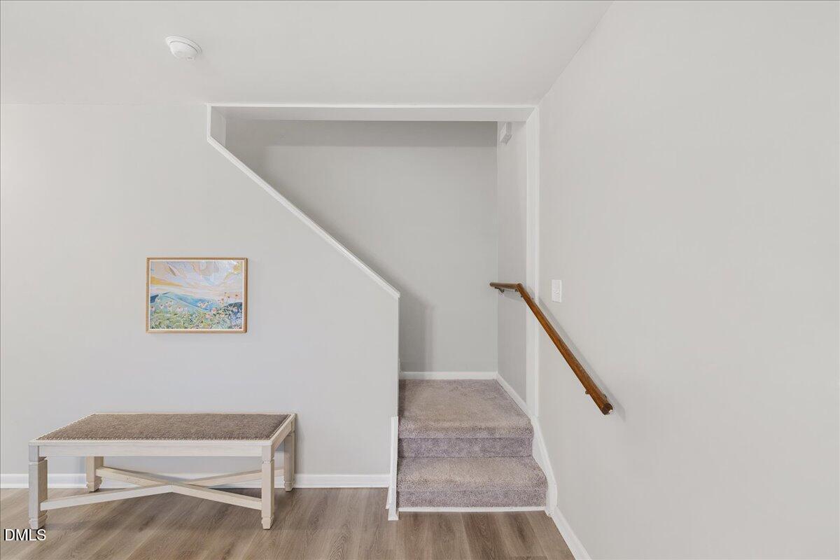 5821 Mapleridge Road Raleigh, NC 27609 - Photo 14 of 38 a view of entryway with stairs and wooden floor