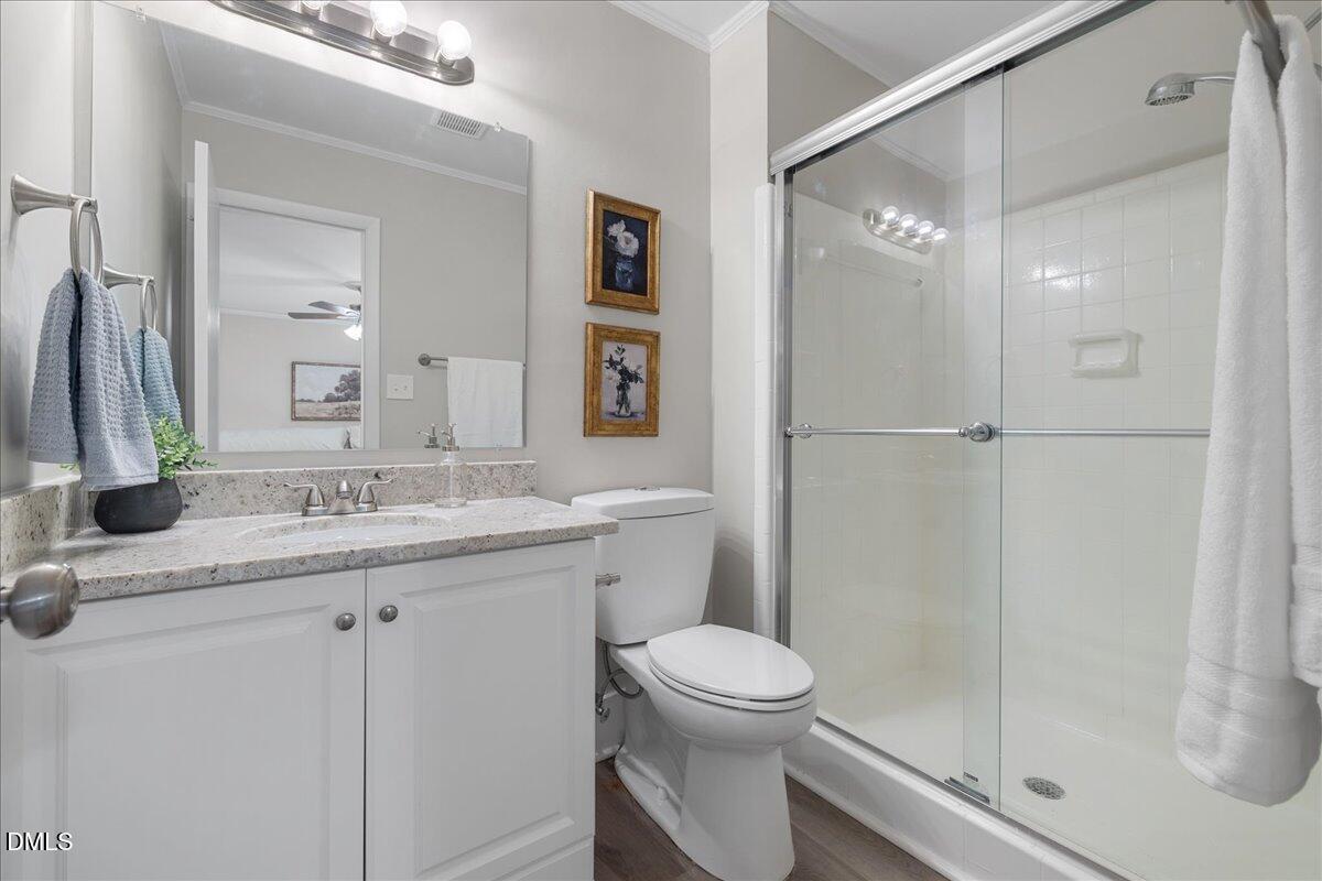 5821 Mapleridge Road Raleigh, NC 27609 - Photo 23 of 38 a bathroom with a granite countertop sink toilet and shower