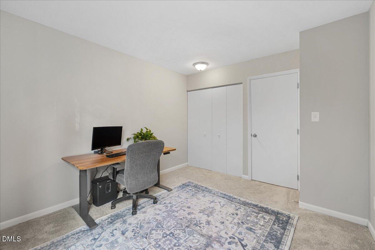 5821 Mapleridge Road Raleigh, NC 27609 - Photo 24 of 38 a workspace with furniture and wooden floor