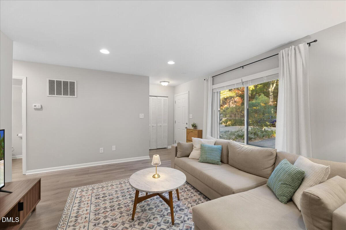 5821 Mapleridge Road Raleigh, NC 27609 - Photo 5 of 38 a living room with furniture and a window