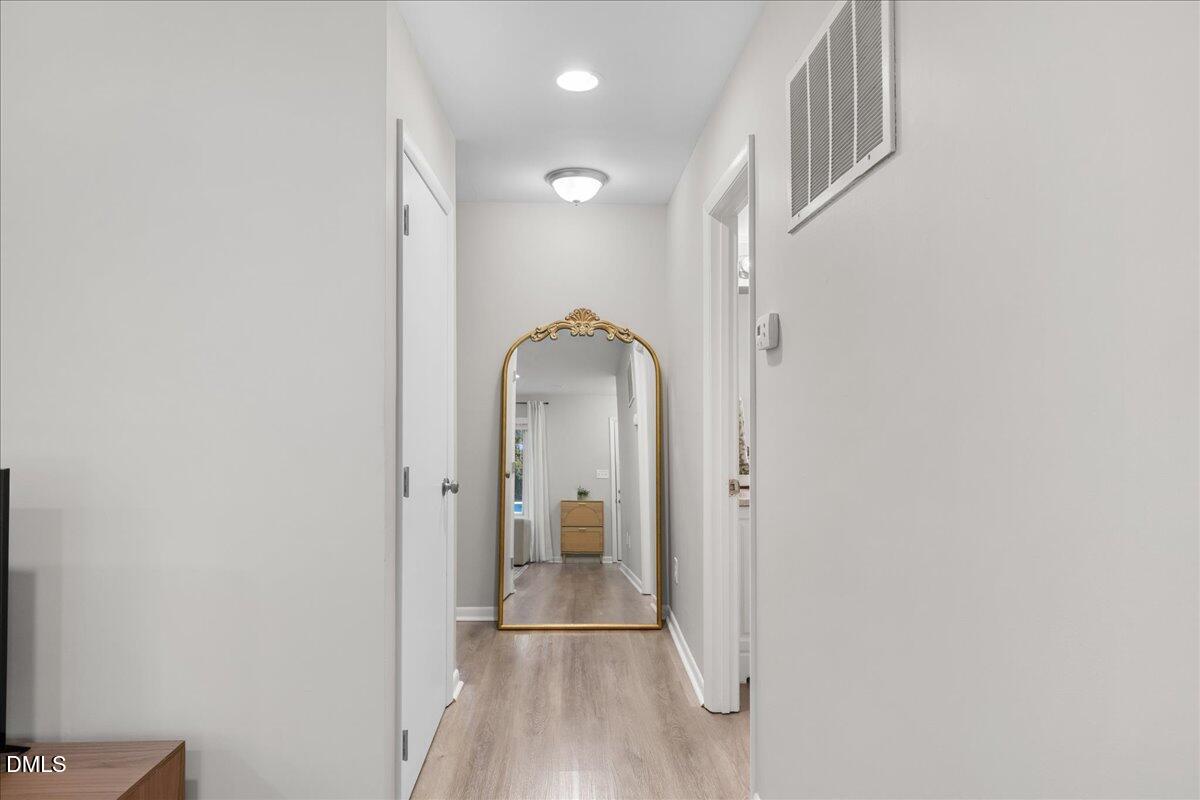 5821 Mapleridge Road Raleigh, NC 27609 - Photo 7 of 38 a view of a hallway with a dining room