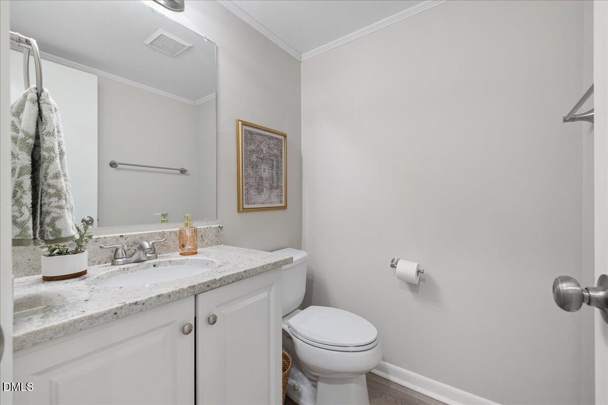 5821 Mapleridge Road Raleigh, NC 27609 - Photo 8 of 38 a bathroom with a granite countertop sink mirror and toilet