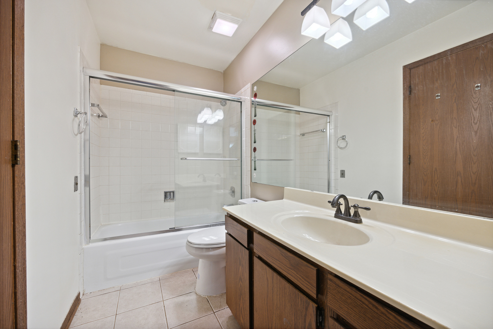 9 Red Barn Road Matteson, IL 60443 - Photo 14 of 18 a bathroom with a sink a toilet a mirror and shower