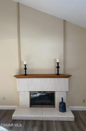 a living room with a fireplace and wooden floor