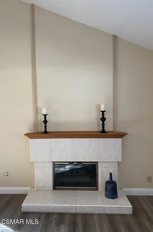 a living room with a fireplace and wooden floor