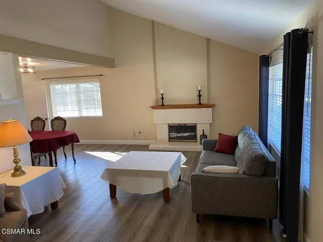 a living room with furniture dining table and a fireplace