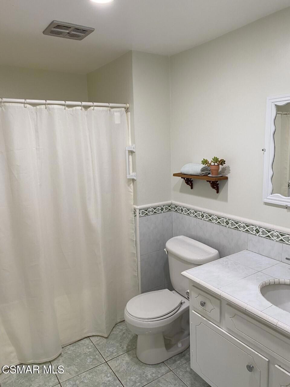 652 Harper Street Simi Valley, CA 93065 - Photo 18 of 27 a white toilet sitting next to a bathroom sink
