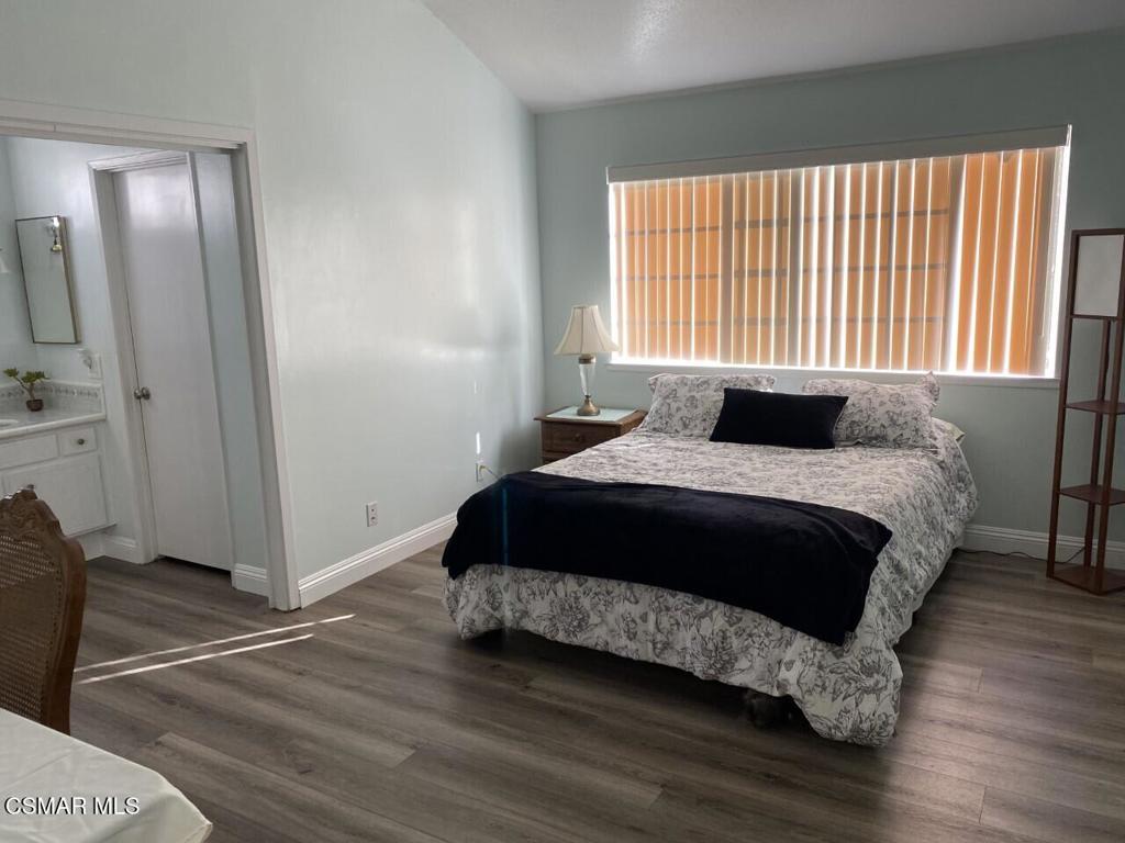 652 Harper Street Simi Valley, CA 93065 - Photo 23 of 27 a bedroom with a bed and wooden floor