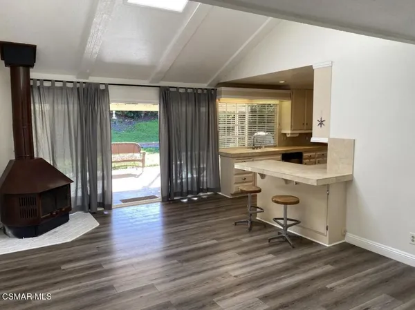 a workspace with wooden floor and a window
