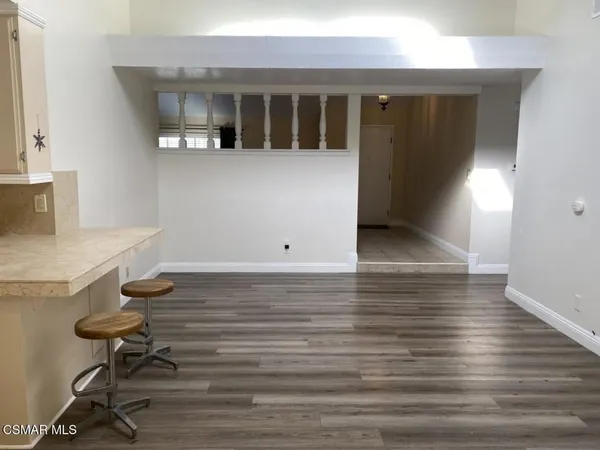 a view of room with furniture and wooden floor