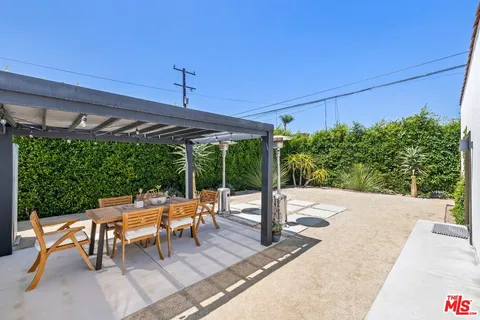 a patio with yard glass top table and chairs