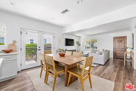 a dining room with furniture and wooden floor