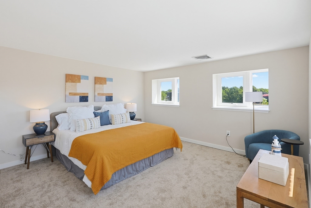 45 Main Street, Unit 35 Wareham, MA 02571 - Photo 18 of 34 a bedroom with a bed and a couch