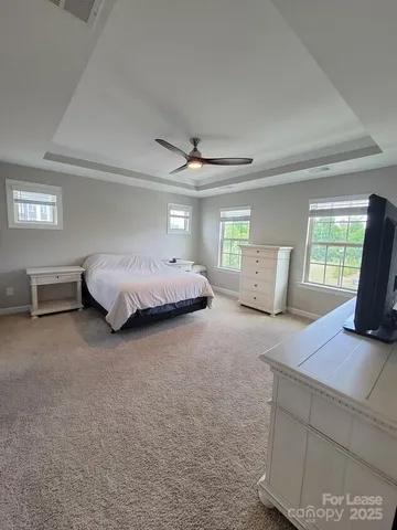 a spacious bedroom with a bed and window