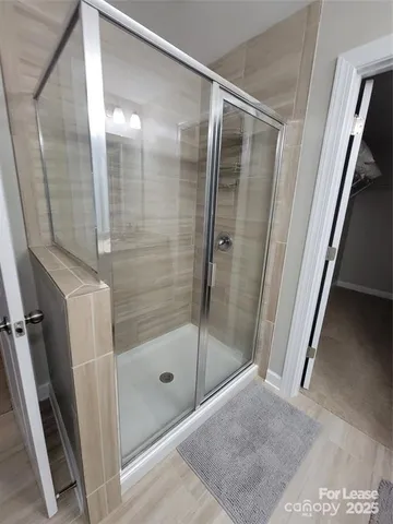a bathroom with a glass door shower