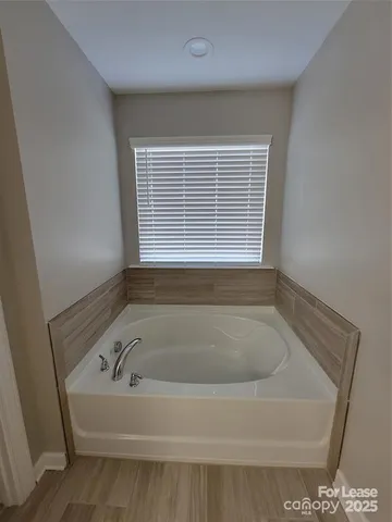 a white bath tub sitting in a bathroom