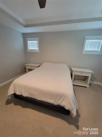 a large bed sitting in a bedroom next to a lamp