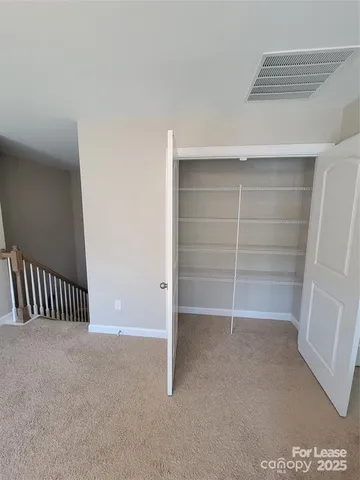 a view of an empty room and a walk in closet