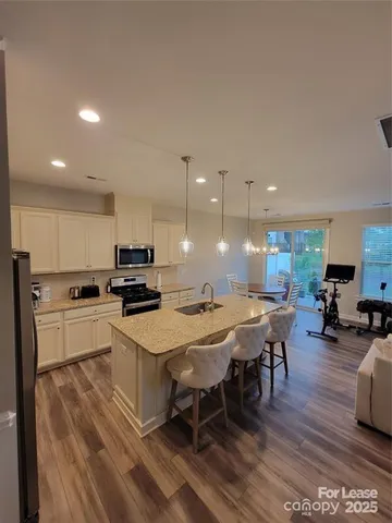 a large kitchen with a table and chairs